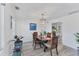 Cozy dining room with wood table, four chairs, pendant lighting, and access to the kitchen at 5404 4Th Avenue Nw Dr, Bradenton, FL 34209