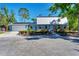 Charming home with blue siding, blue shutters, brick accents, mature landscaping and a two car garage at 5404 4Th Avenue Nw Dr, Bradenton, FL 34209