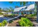 Charming home featuring brick accents, a metal roof, an inviting front yard, and light blue shutters at 5404 4Th Avenue Nw Dr, Bradenton, FL 34209
