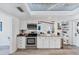 Bright kitchen with stainless steel appliances, white cabinets, and decorative tin ceiling at 5404 4Th Avenue Nw Dr, Bradenton, FL 34209