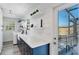 Updated laundry room with white shiplap walls, navy cabinets, and access to a screened patio at 5404 4Th Avenue Nw Dr, Bradenton, FL 34209