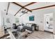 Comfortable living room with exposed wood beams, stylish furniture, and bright natural light at 5404 4Th Avenue Nw Dr, Bradenton, FL 34209