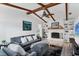 Spacious living room with exposed beams, a fireplace, and built-in shelving at 5404 4Th Avenue Nw Dr, Bradenton, FL 34209