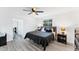 Comfortable bedroom with modern decor, wood-look flooring, and bright natural light at 5404 4Th Avenue Nw Dr, Bradenton, FL 34209