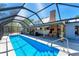 Inviting screened-in pool with a covered patio, brick fireplace, and ample space for entertaining at 5404 4Th Avenue Nw Dr, Bradenton, FL 34209