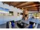 Covered porch featuring a brick fireplace, dart board, and TV, perfect for outdoor entertainment at 5404 4Th Avenue Nw Dr, Bradenton, FL 34209