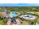 Aerial view of pool, playground, clubhouse and lush landscaping in a community at 5688 Woodland Sage Dr, Sarasota, FL 34238