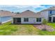 Backyard view featuring a well maintained lawn and screened in lanai at 5688 Woodland Sage Dr, Sarasota, FL 34238