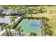 Aerial view of basketball court alongside clubhouse, playground, landscaping, and parking area at 5688 Woodland Sage Dr, Sarasota, FL 34238