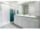 Bathroom featuring a double vanity, walk-in shower, tub and tiled flooring at 5688 Woodland Sage Dr, Sarasota, FL 34238