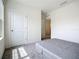 Neutral bedroom with a view of a connected room and a neutral colored carpet at 5688 Woodland Sage Dr, Sarasota, FL 34238