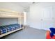 Neutral bedroom featuring a bunk bed, soft carpet, and bright lighting at 5688 Woodland Sage Dr, Sarasota, FL 34238