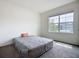 Neutral bedroom with large window overlooking the neighborhood and neutral colored carpet at 5688 Woodland Sage Dr, Sarasota, FL 34238