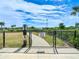 Gated community dog park with mature trees on a sunny day at 5688 Woodland Sage Dr, Sarasota, FL 34238