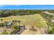 Expansive green space bordered by palm trees and lush landscaping at 5688 Woodland Sage Dr, Sarasota, FL 34238