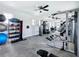Bright gym featuring weight machines, dumbbells, exercise balls, flat screen TV and ceiling fans at 5688 Woodland Sage Dr, Sarasota, FL 34238