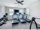 Bright gym featuring treadmills, stationary bike, ceiling fan and large windows at 5688 Woodland Sage Dr, Sarasota, FL 34238