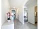 Inviting hallway with arched doorways and tile flooring, offering a glimpse into adjacent rooms at 5688 Woodland Sage Dr, Sarasota, FL 34238