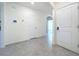 Clean, bright hallway with tile floors, leading to various rooms, and featuring a smart home panel at 5688 Woodland Sage Dr, Sarasota, FL 34238