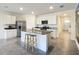 Well-lit kitchen features stainless steel appliances, granite countertops, and large island with bar seating at 5688 Woodland Sage Dr, Sarasota, FL 34238