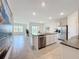 Spacious open kitchen featuring a granite island, stainless steel appliances, and an adjacent living area at 5688 Woodland Sage Dr, Sarasota, FL 34238
