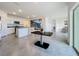 Open-concept living area featuring kitchen with island, dining area, and sliding glass doors to the backyard at 5688 Woodland Sage Dr, Sarasota, FL 34238