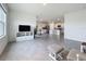 Open living room with views into the kitchen, access to the backyard, and cozy seating at 5688 Woodland Sage Dr, Sarasota, FL 34238