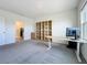 Bright office features carpet floors, bright window, storage shelves and desk at 5688 Woodland Sage Dr, Sarasota, FL 34238