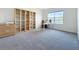 Home office featuring carpet floors, bright window and storage shelves at 5688 Woodland Sage Dr, Sarasota, FL 34238