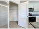 Functional kitchen pantry with wire shelving, providing ample storage space next to modern appliances at 5688 Woodland Sage Dr, Sarasota, FL 34238