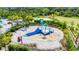 Aerial view of splash pad surrounded by lounge chairs and lush tropical landscaping at 5688 Woodland Sage Dr, Sarasota, FL 34238
