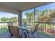 Outdoor balcony with seating overlooking verdant landscaped grounds and a tranquil pond at 6501 Stone River Rd # 209, Bradenton, FL 34203