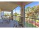 Screened outdoor balcony with seating overlooking verdant landscaped grounds and a tranquil pond at 6501 Stone River Rd # 209, Bradenton, FL 34203
