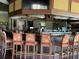 Bar with decorative chairs and well-stocked liquor selection at 6501 Stone River Rd # 209, Bradenton, FL 34203