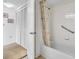 Bright bathroom featuring a shower-tub combination with handrails and storage in the closet at 6501 Stone River Rd # 209, Bradenton, FL 34203