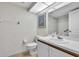 Clean bathroom with a single sink vanity, toilet, and framed mirror at 6501 Stone River Rd # 209, Bradenton, FL 34203