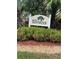 Welcoming entrance sign for The Terraces community, surrounded by lush landscaping at 6501 Stone River Rd # 209, Bradenton, FL 34203