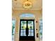 Entrance to the clubhouse features a chandelier and views to the outside at 6501 Stone River Rd # 209, Bradenton, FL 34203