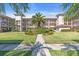 Beautiful condominium building surrounded by lush landscaping and mature palm trees at 6501 Stone River Rd # 209, Bradenton, FL 34203