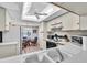 Bright kitchen with appliances, eat-in kitchen and a light fixture above the dining table at 6501 Stone River Rd # 209, Bradenton, FL 34203