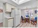 Eat-in kitchen with a light fixture, dining table, and a combination refrigerator at 6501 Stone River Rd # 209, Bradenton, FL 34203