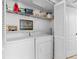 Bright laundry area featuring a washer, dryer, storage shelf and closet space at 6501 Stone River Rd # 209, Bradenton, FL 34203