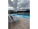 Large community pool featuring covered lounge areas, perfect for relaxing by the water at 6501 Stone River Rd # 209, Bradenton, FL 34203