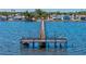 A sweeping aerial perspective captures a pier extending into the serene water amidst a charming seaside town at 7 Braden Castle Dr, Bradenton, FL 34208