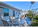 Inviting back patio with outdoor dining set, lush landscaping, and shade at 7 Braden Castle Dr, Bradenton, FL 34208