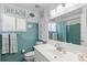 Vintage-style bathroom featuring a retro-tile backsplash and ample vanity space at 7 Braden Castle Dr, Bradenton, FL 34208
