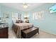 Cozy bedroom with soothing mint walls, two windows, and a wall-mounted television at 7 Braden Castle Dr, Bradenton, FL 34208