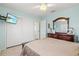 Bedroom featuring ample closet space, a dresser, and a wall-mounted television at 7 Braden Castle Dr, Bradenton, FL 34208