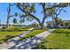 Grassy community park with picnic tables, sidewalks, and shade trees, offers a place for residents to relax and socialize at 7 Braden Castle Dr, Bradenton, FL 34208