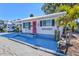 Charming home featuring a bright pink door, white exterior, and a well-maintained, painted front patio area at 7 Braden Castle Dr, Bradenton, FL 34208
